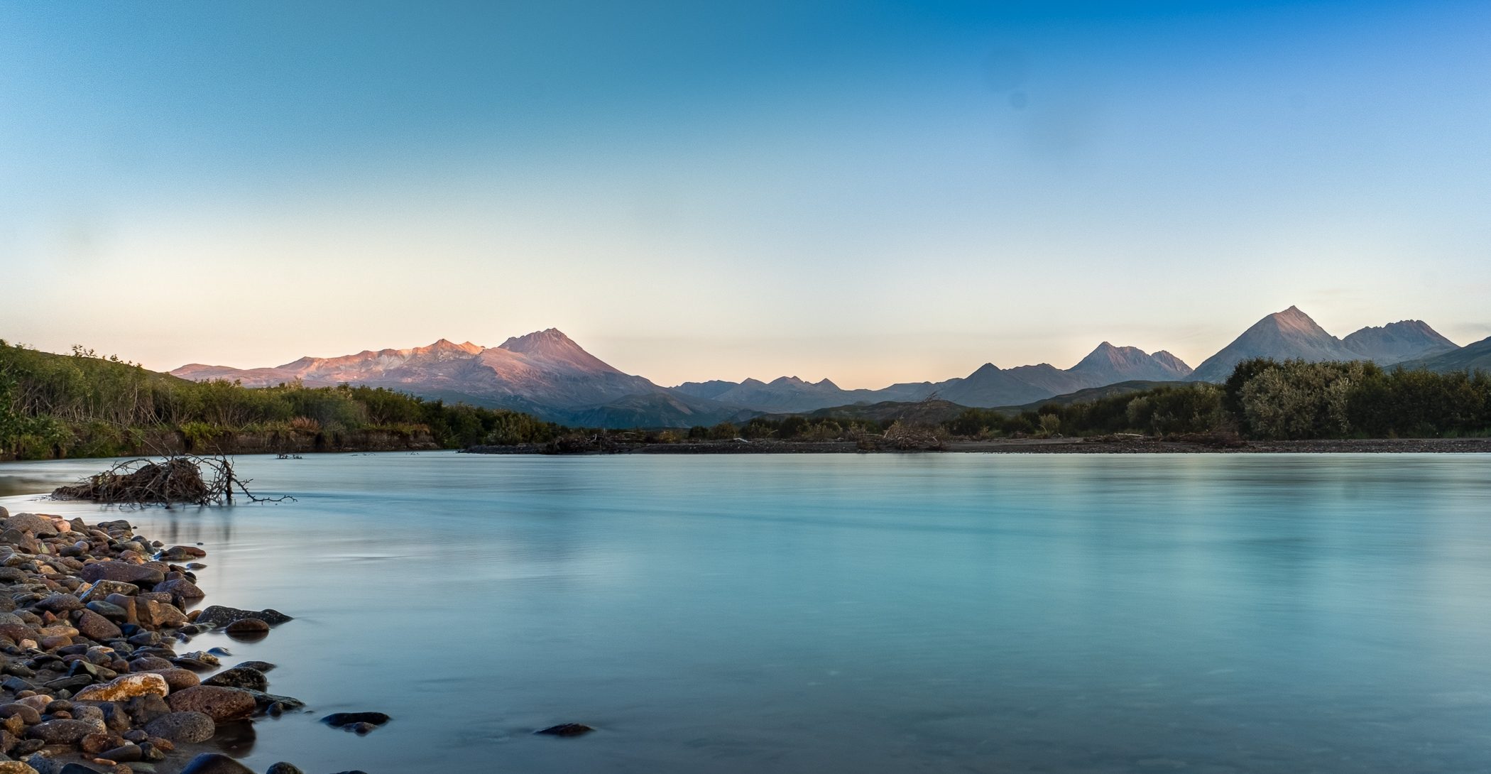 The Naknek River at dusk near King Salmon, Alaska, with the mountains catching the last light